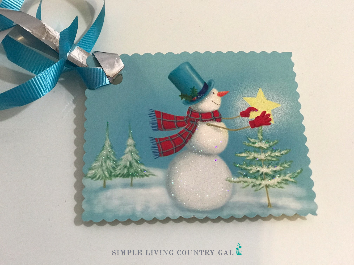 A hand-made gift tag cut from the front of a Christmas card. 
