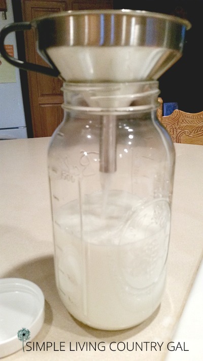 A glass jar of fresh goat milk 