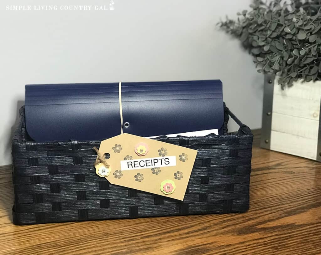 a blue baskest with a small file inside with a label that says receipts on the front