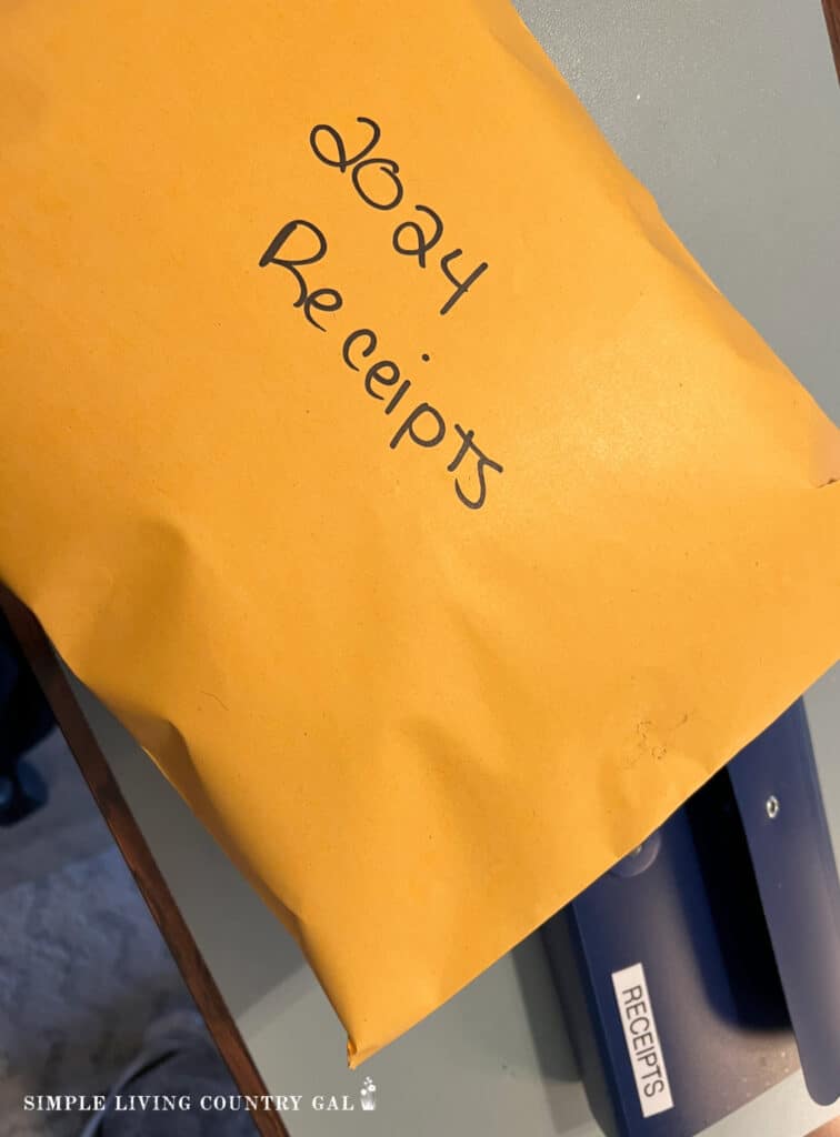 a large envelope labeled 2024 receipts next to a blue accordion file