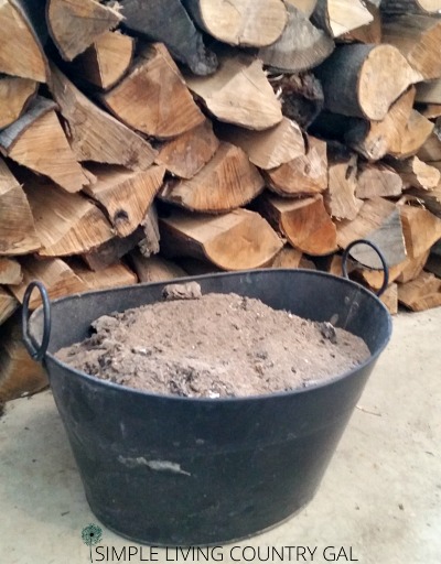A bucket of wood ash is ready for use on your homestead