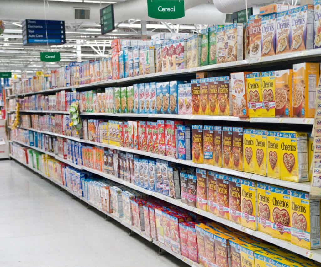 shelves stocked full of cereal options in a grocery store 