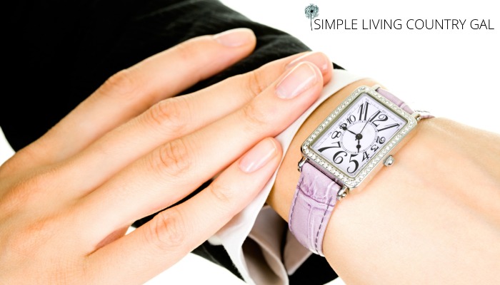 a pink watch on a woman's wrist 