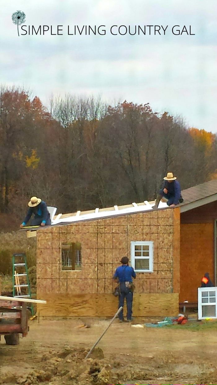 amish men building a barn addition 