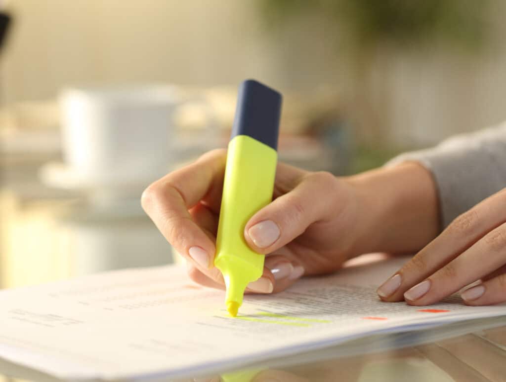 Woman hand underlining tasks on a to do list