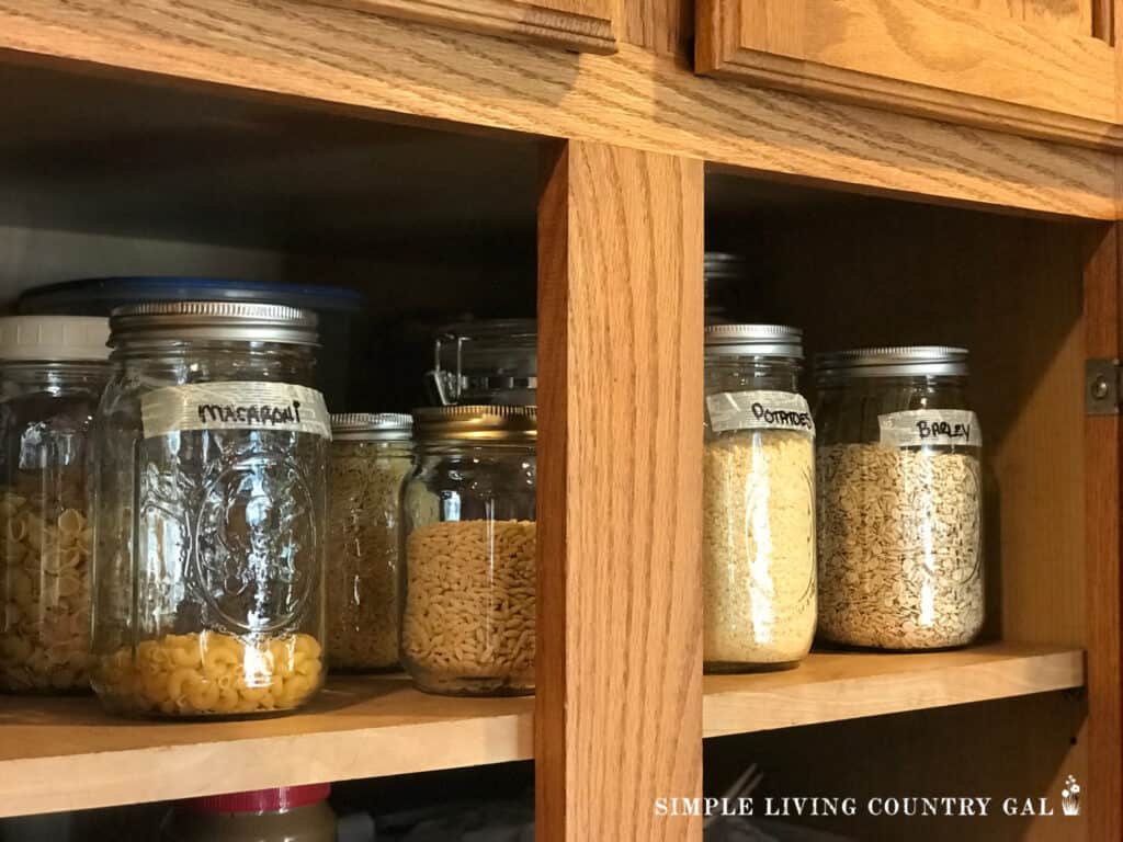 mason jars on a pantry shelf filled with food