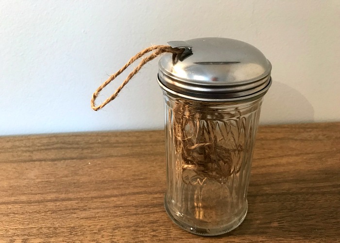 A spool of twine in a sugar container with a metal lid is a cheap way to organize supplies in your craft room. 