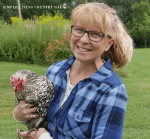 a girl in a blue shirt holding a chicken