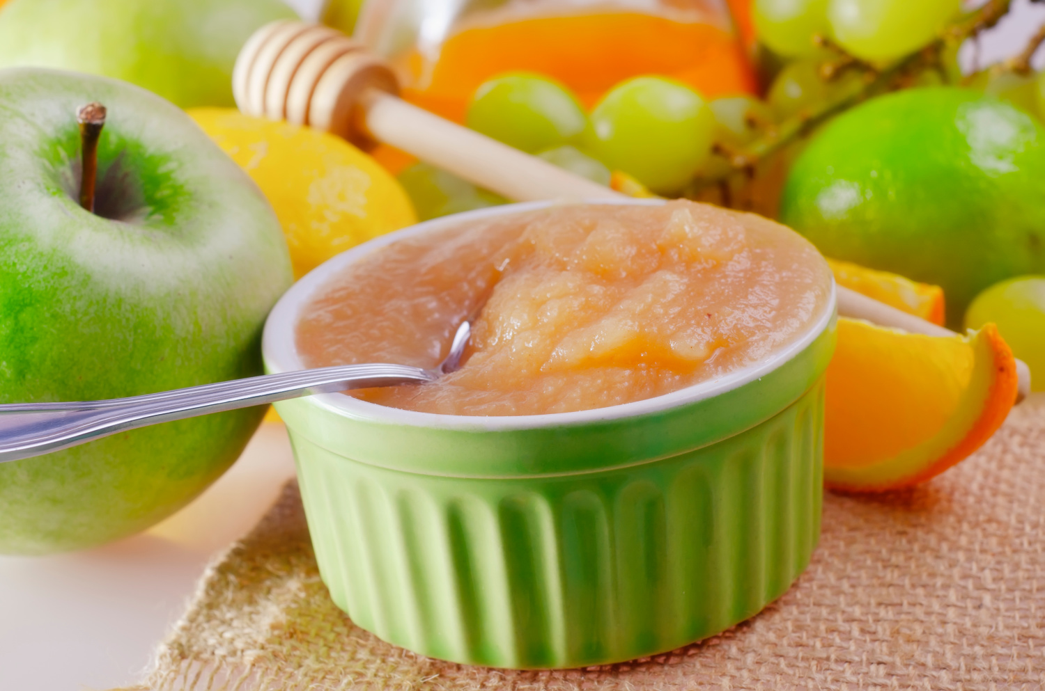 A dish of homemade applesauce that was canned and preserved. You too can make your own canned applesauce, even if you are a beginner. 