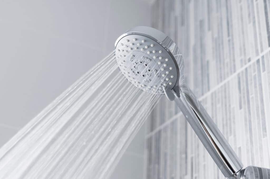 a shower head with water spraying out of it