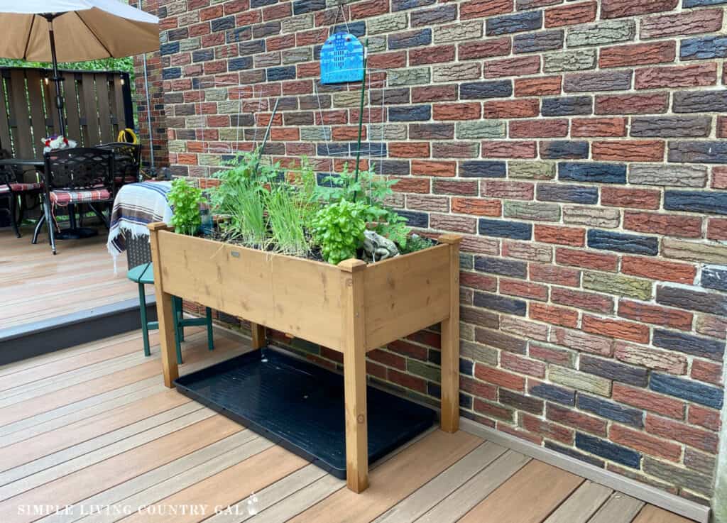 a wooden raised garden table on a patio