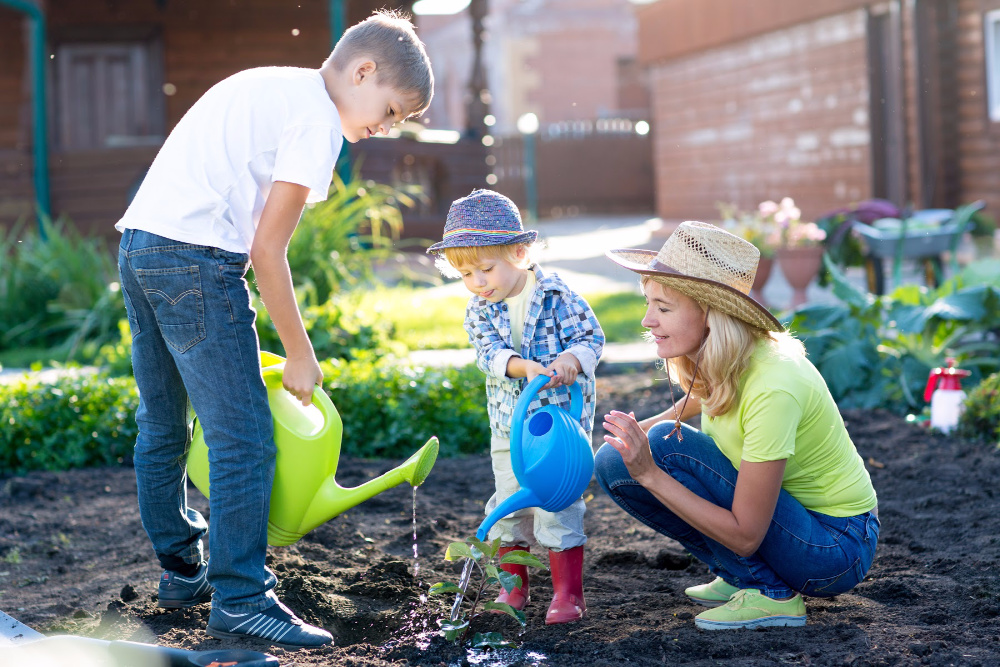 kids watering vegetables in a baby food garden