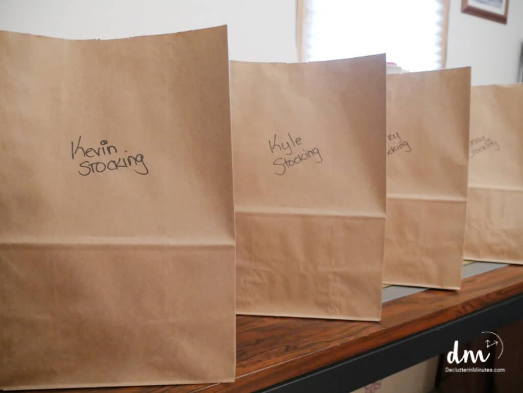 brown bags with name on the front filled with gifts