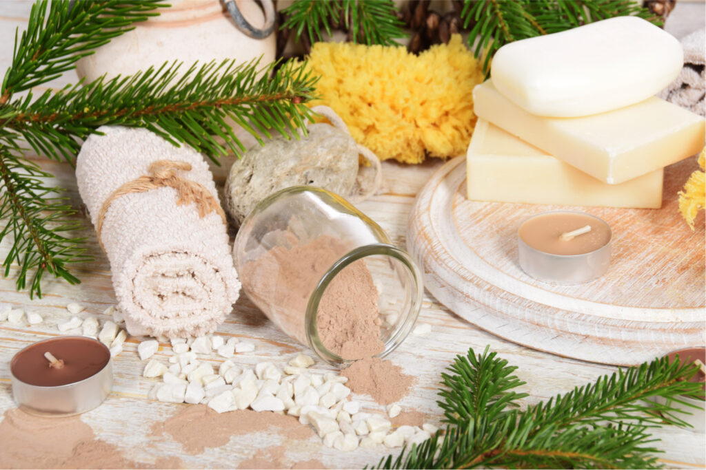 body scrub, towels, soaps, and candles on a display table