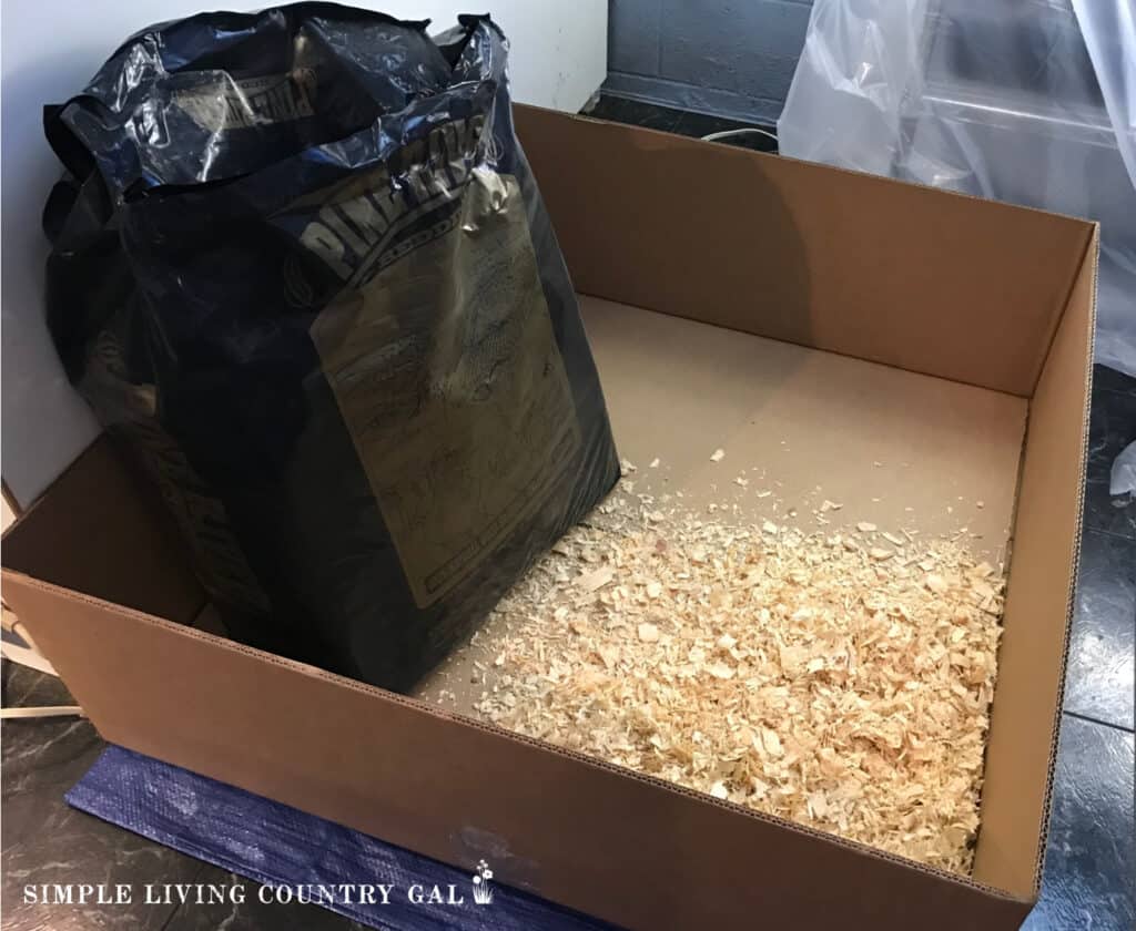 a cardboard box with a bag of wood shavings