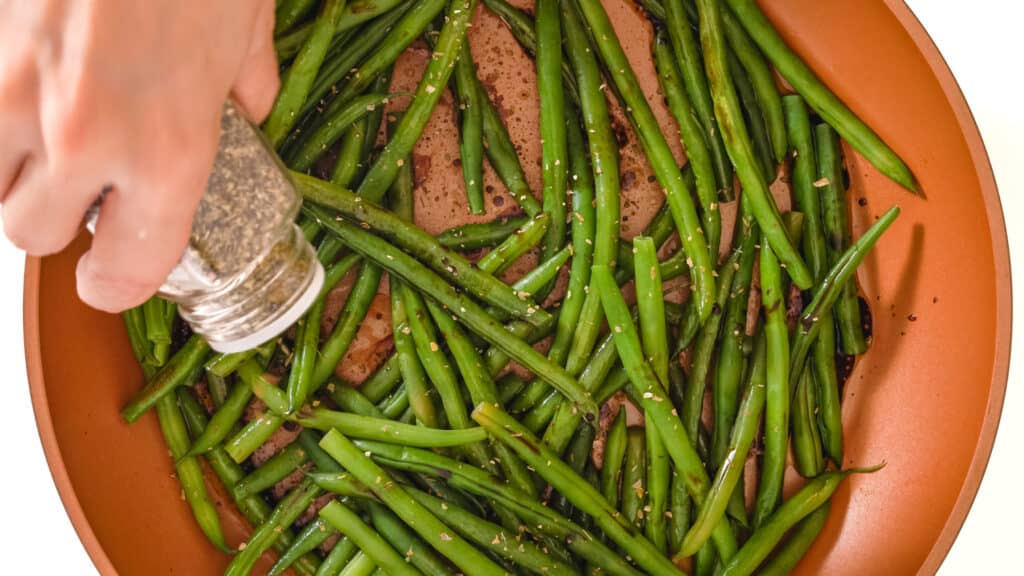 a dish of cooked seasoned green beans