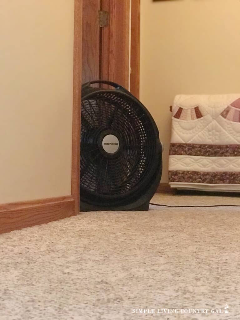 fan in a hallway helping to keep a house cool without central air 