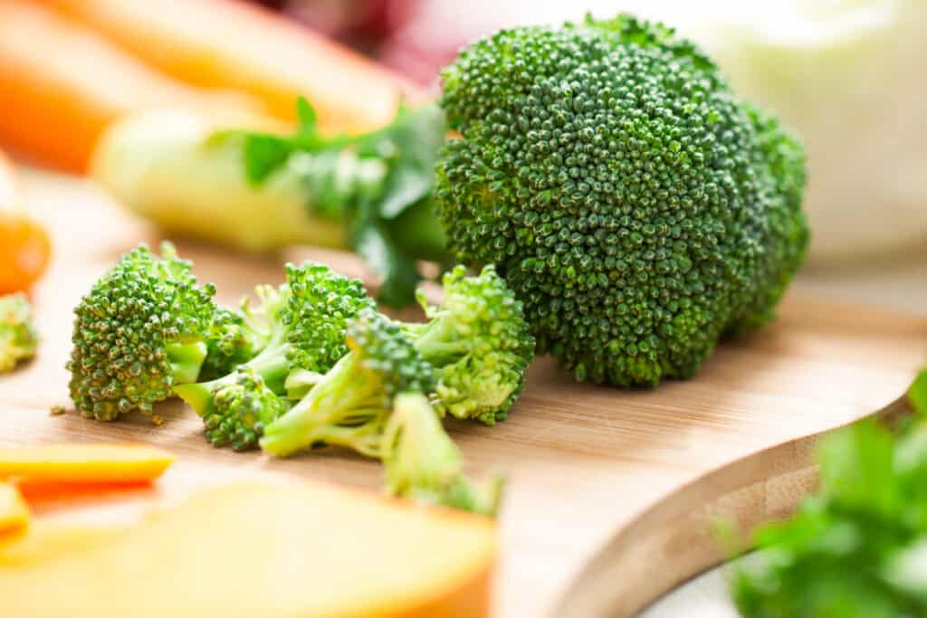 Fresh green broccoli on a cutting board.