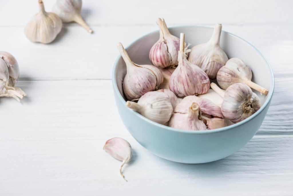 a dish of garlic heads ready for planting