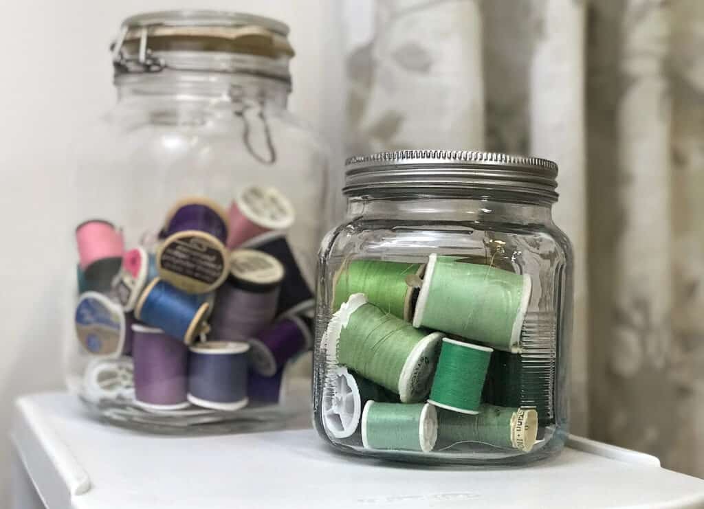 sewing threads in large jars