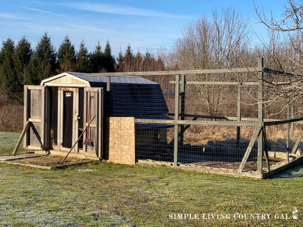 a chicken coop shed with a fenced in outdoor area