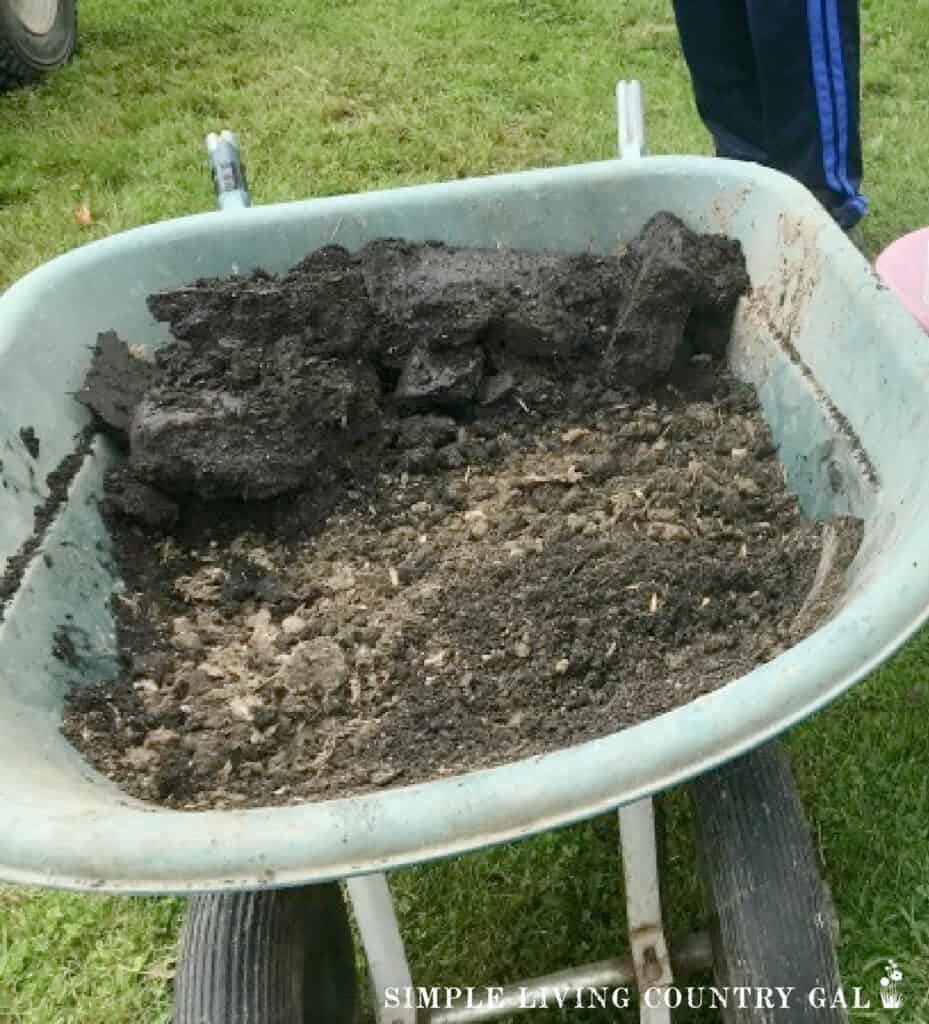 a wheelbarrow filled with fresh compost