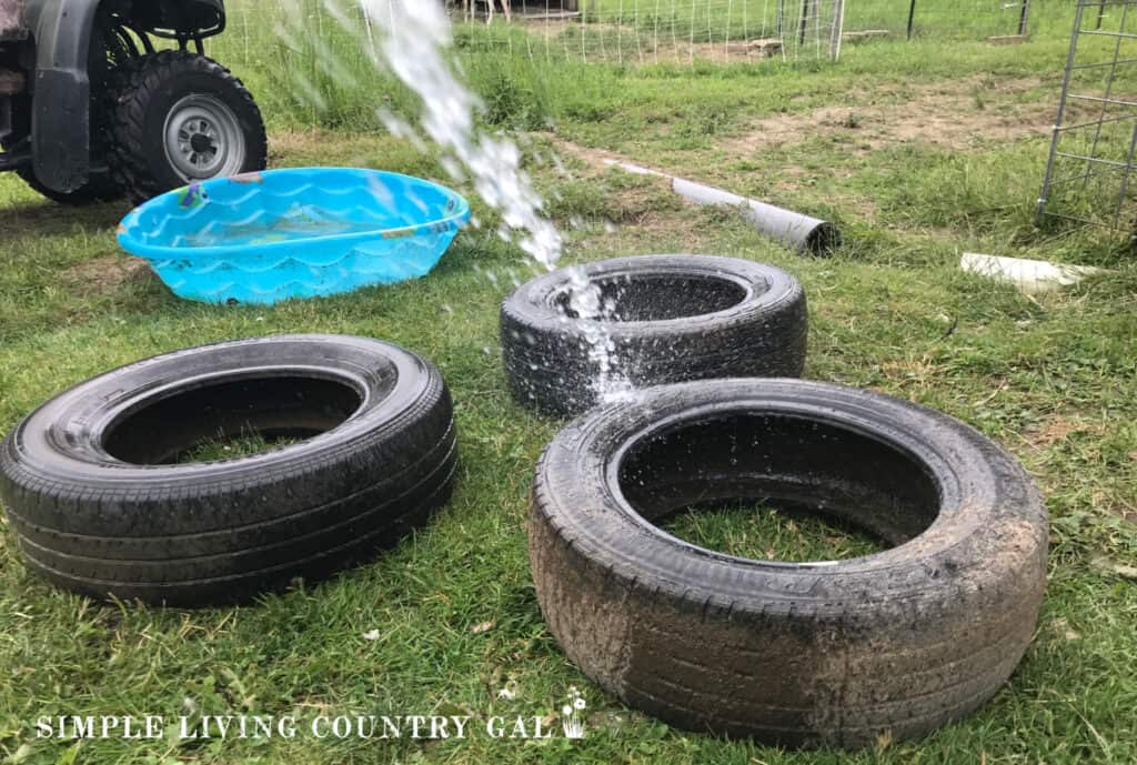a hose washing down a set of tires