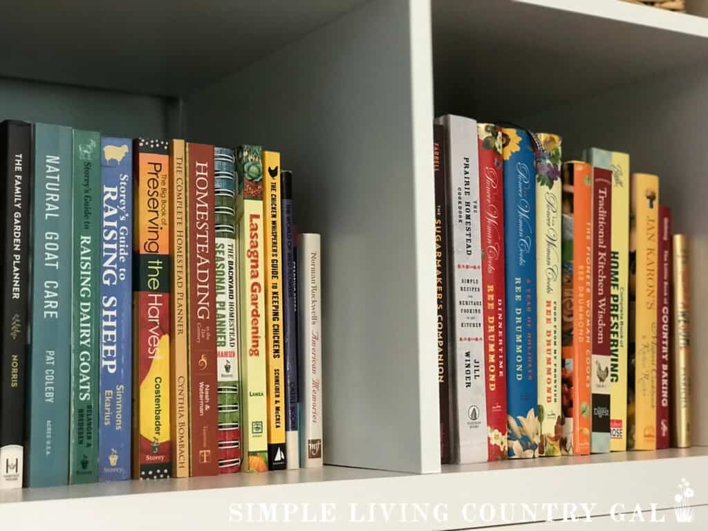 a collection of gardening books on a white bookshelf