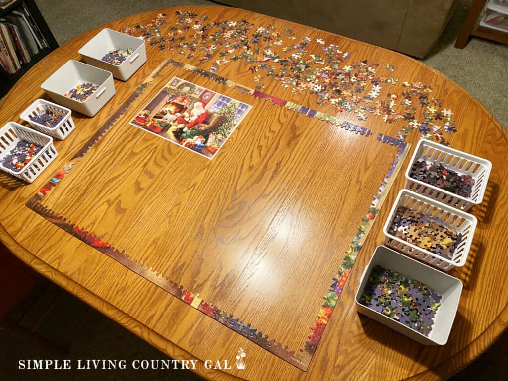 a holiday puzzle on a table with baskets around the side with pieces in it