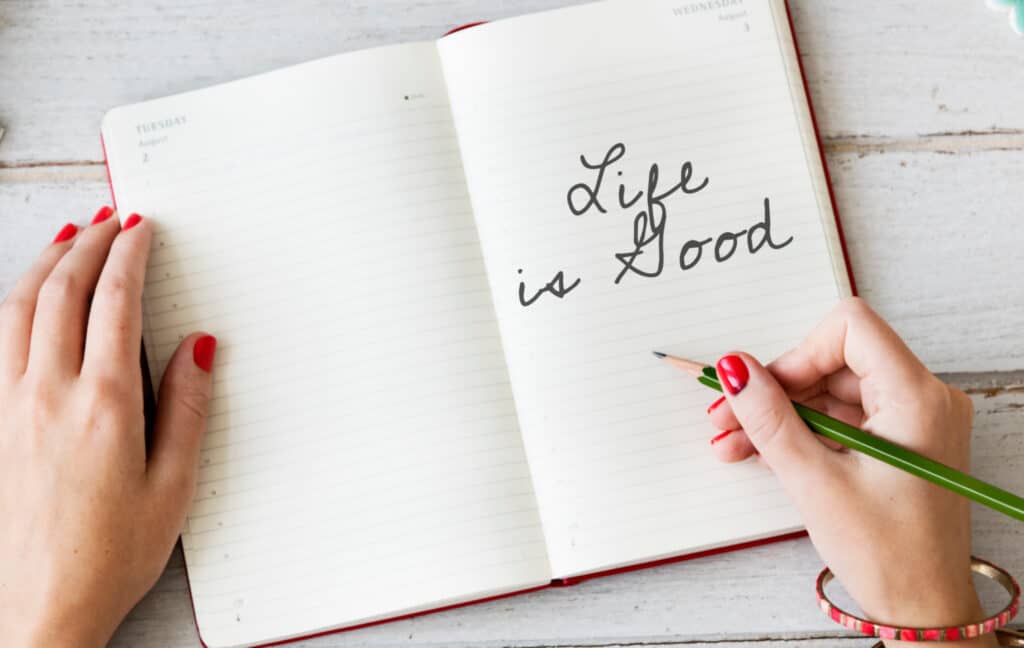 an open note book with the words "life is good" written on the page