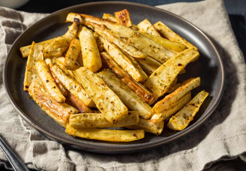 A dish of Roasted Parnsip Fries with Salt Pepper and Thyme