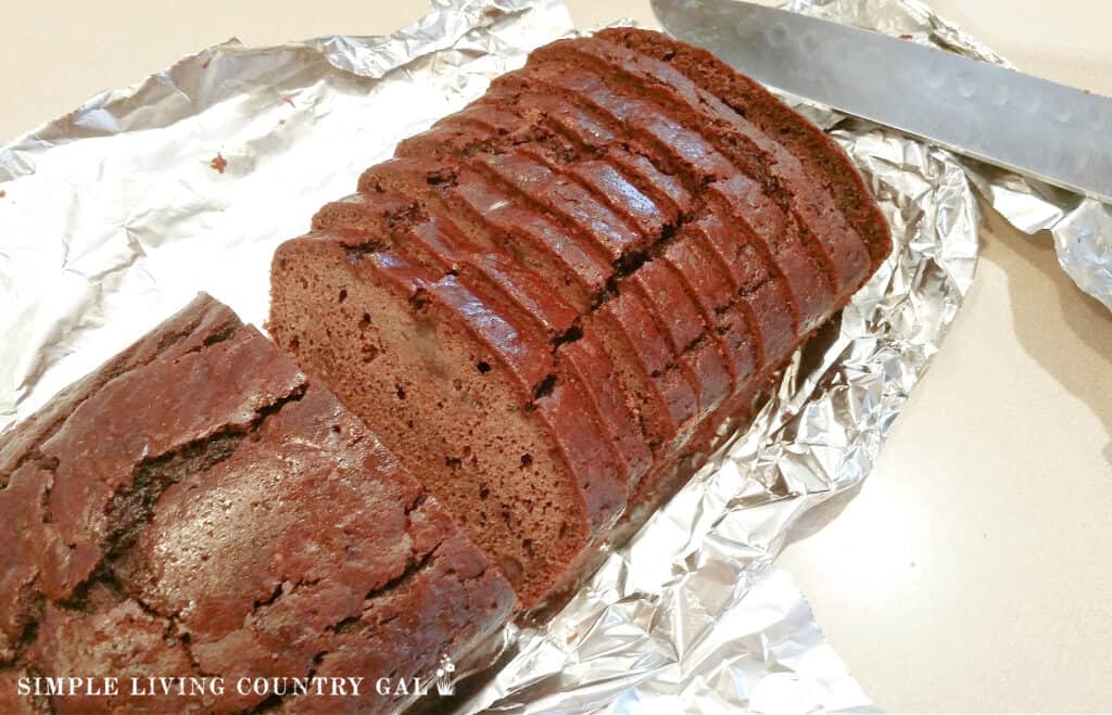 zucchini bread sliced on a sheet of tin foil