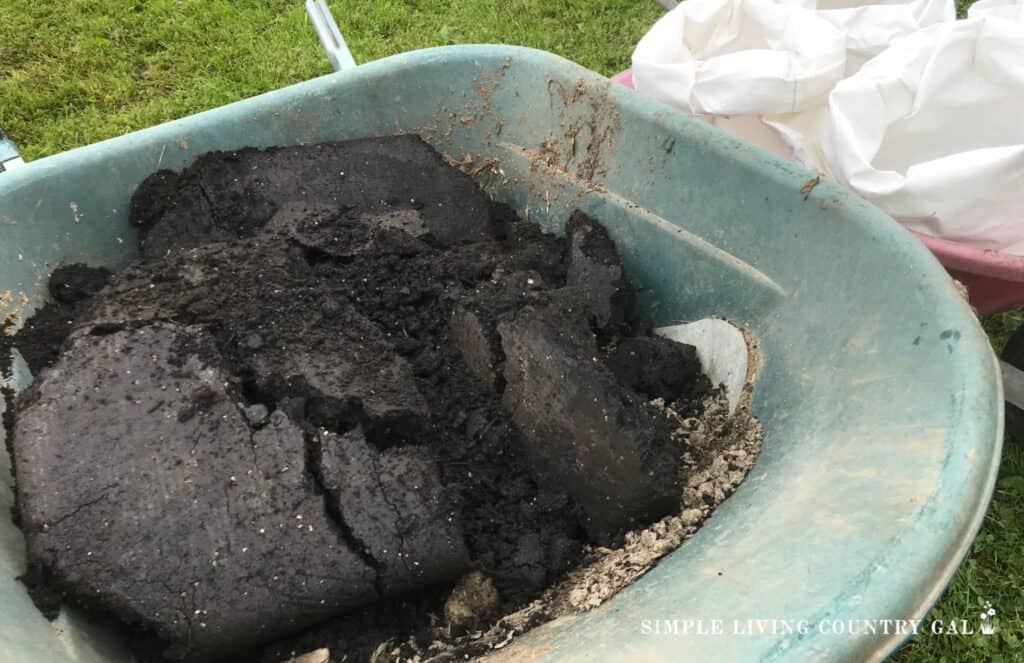 a wheelbarrow of soil