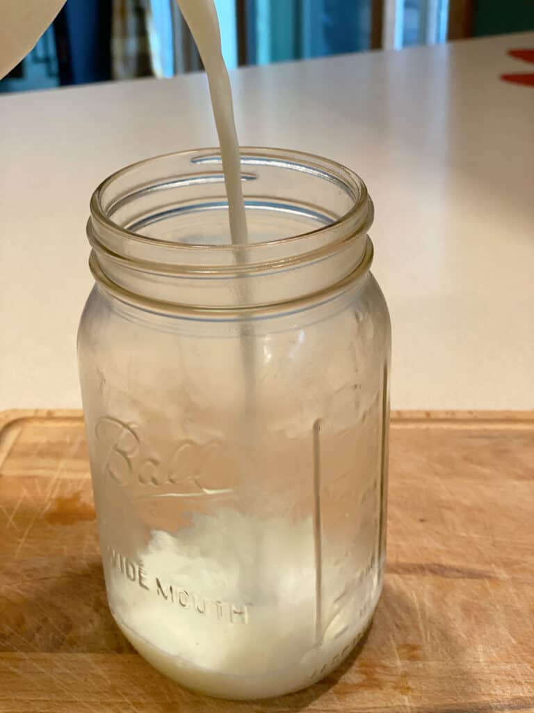 pouring milk into a mason jar (1)