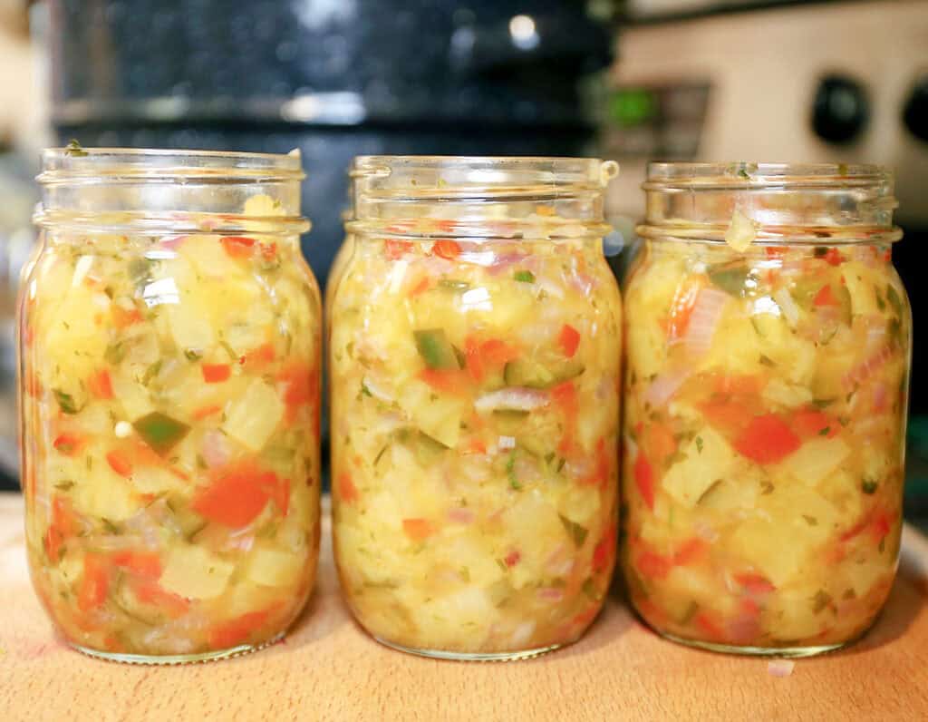 3 jars of veggie + pineapple salsa on a counter