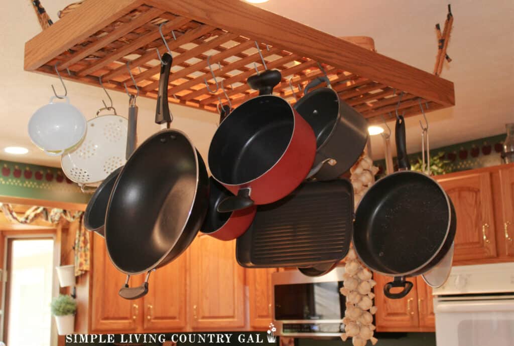 a hanging rack holding pots in a simplified kitchen