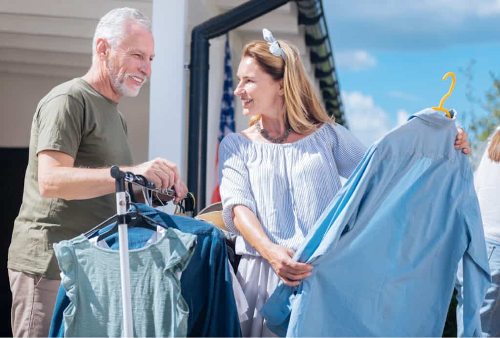 an older couple shopping at a yard sale a great simple thrifty living tip.