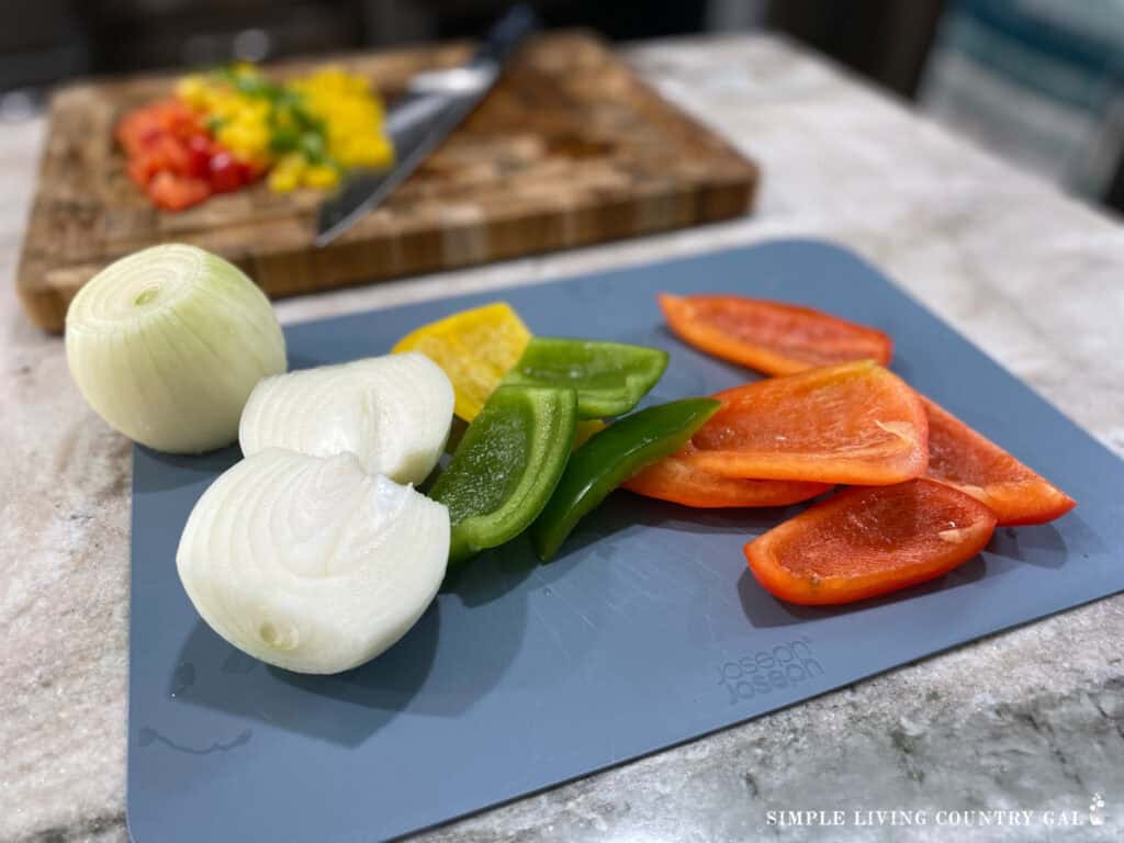 chopped peppers and onions on a cutting board