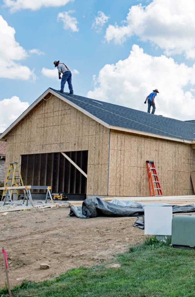 amish putting on a new roof to a home 
