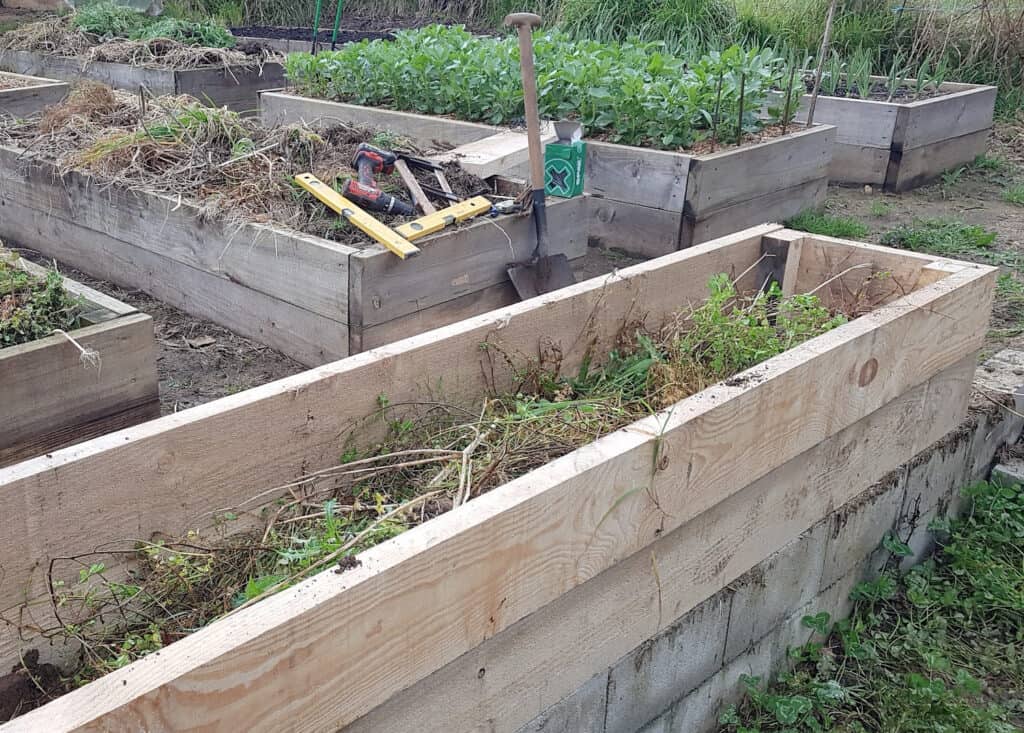 A set of wooden raised beds in a vegetable garden 
