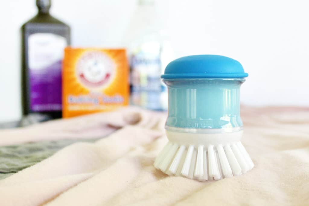 DIY laundry stain remover in a dish scrubber