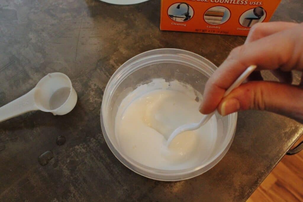mixing homemade oven cleaner with a spoon