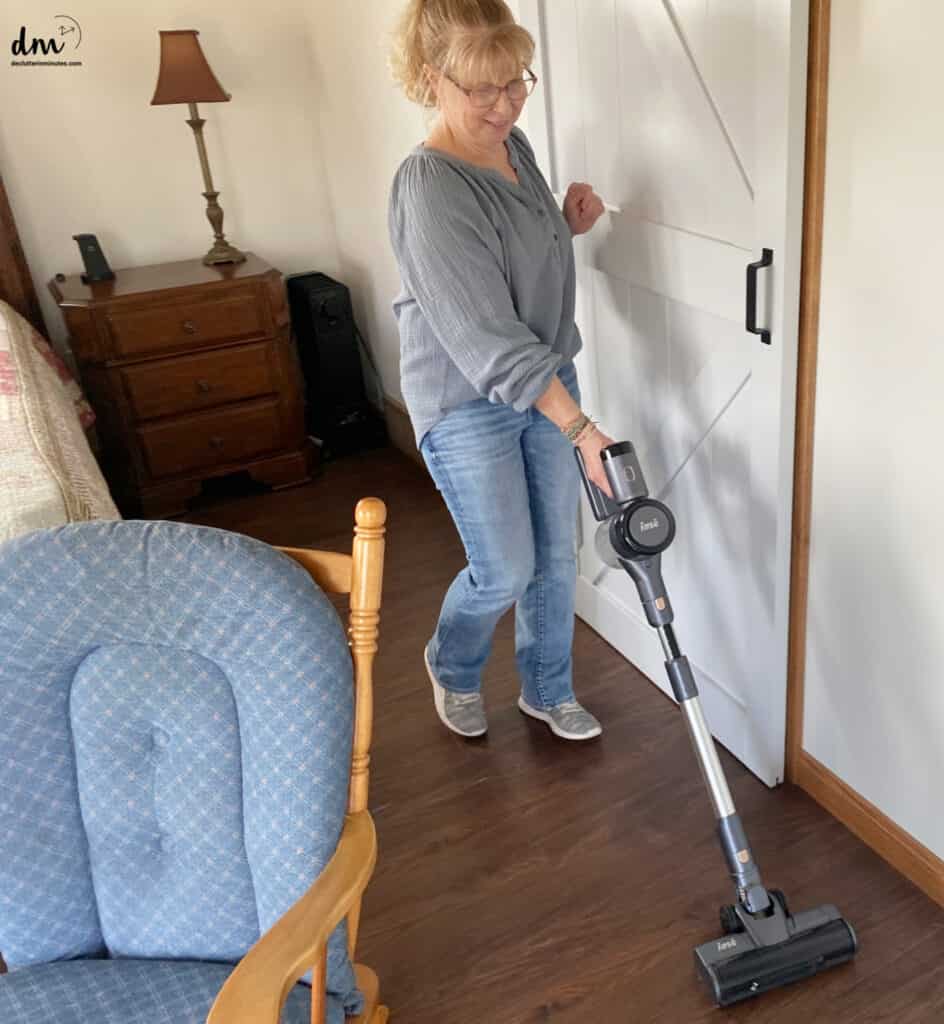 woman spring cleaning a floor in a bedroom