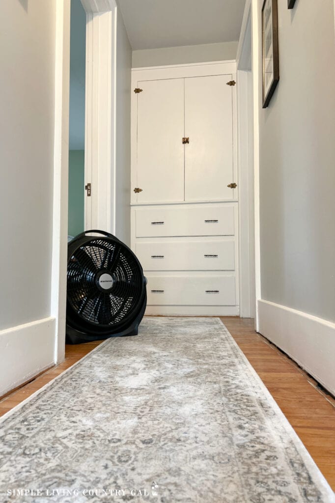 a black fan sitting in a hallway