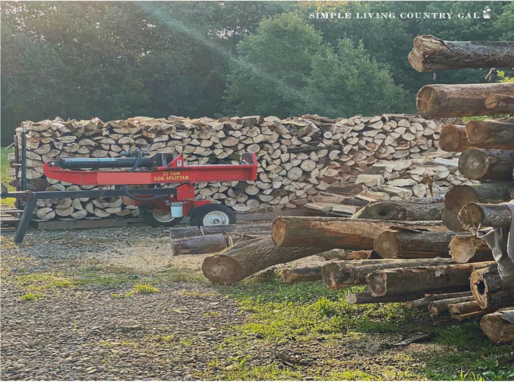 pile of split wood near a wood splitter on a homestead