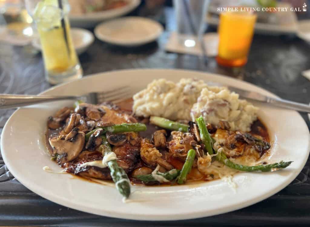 a dish of chicken and asparagus with mashed potatoes