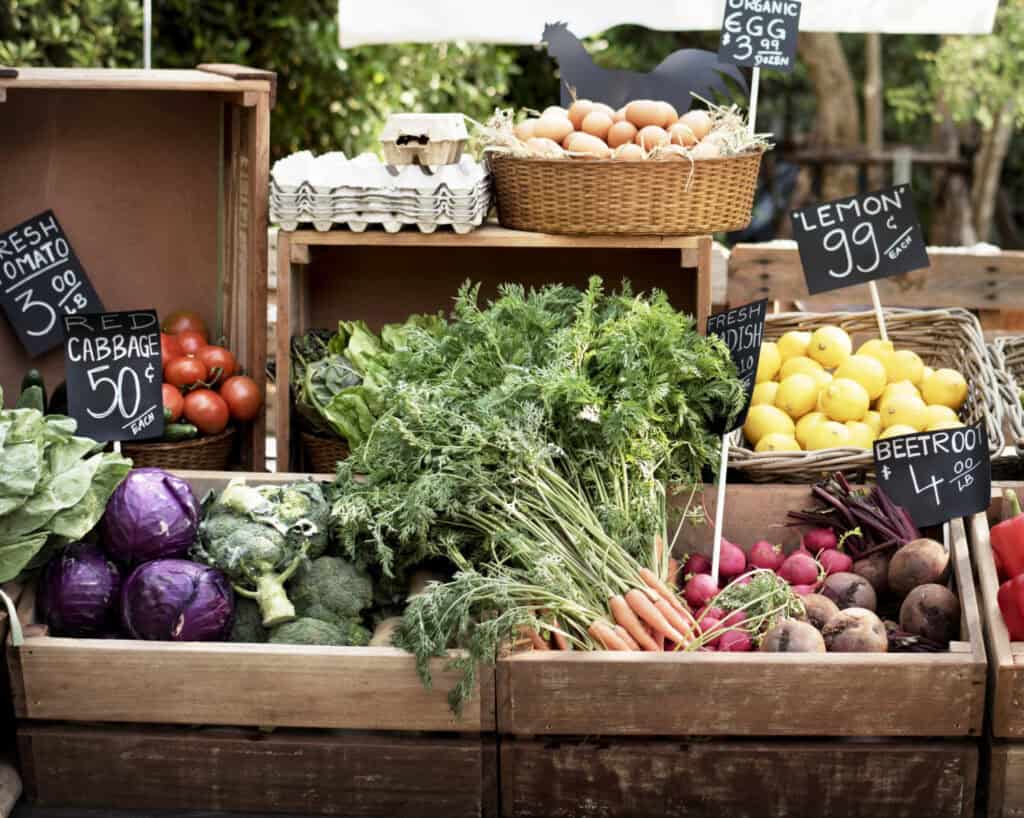 a farmers market with produce and eggs for sale
