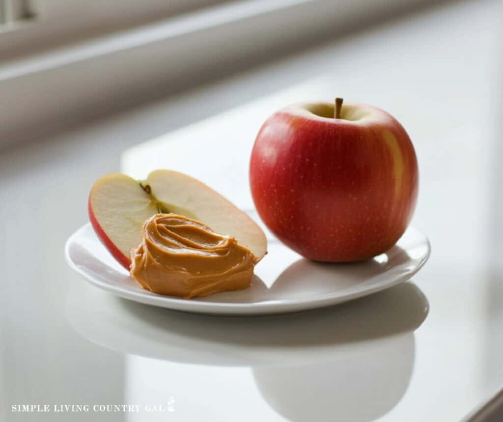 a slice of apple on a plate with peanut butter on top