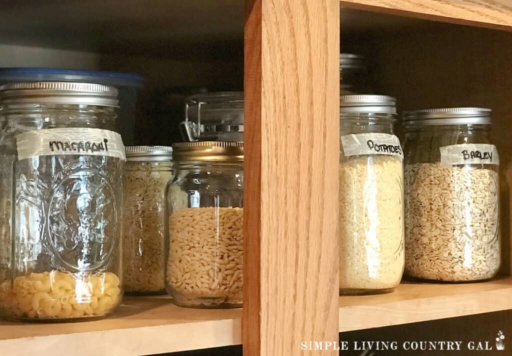 labeled mason jars on a shelf in a pantry