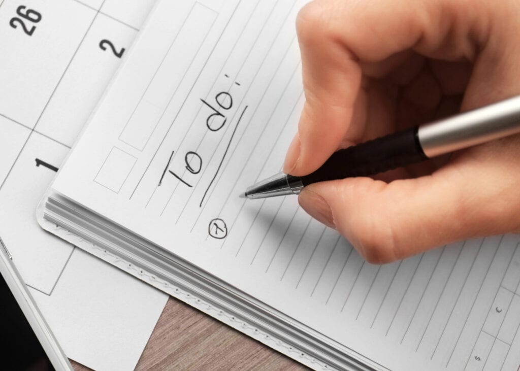 a hand writing tasks on a to do list